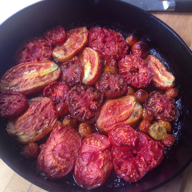 tomatoes roasting in cast iron pan